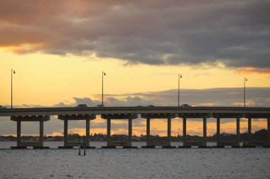 Barron Collier Bridge and Gilchrist Bridge in Florida with moving traffic. Transportation infrastructure in Charlotte County connecting Punta Gorda and Port Charlotte over Peace River.
