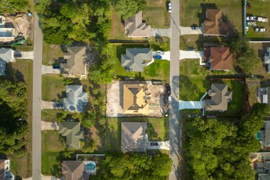 Aerial view of suburban private house wit wooden roof frame under construction in Florida quiet rural area.