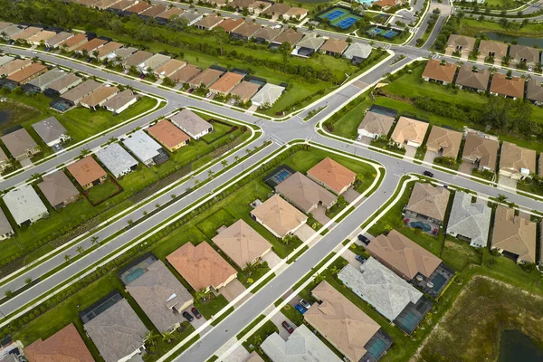 View from above of densely built residential houses in closed living clubs in south Florida. American dream homes as example of real estate development in US suburbs.