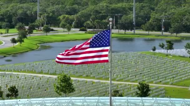 Large American Flag Waving Army National Cemetery Rows White Tombstones — Stock Video