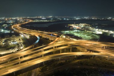 Aerial view of american highway junction at night with fast driving vehicles in Tampa, Florida. View from above of USA transportation infrastructure.
