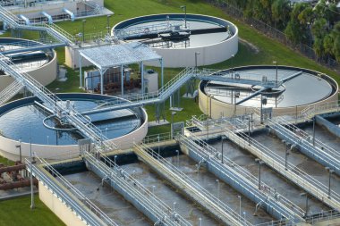 Aerial view of modern water cleaning facility at urban wastewater treatment plant. Purification process of removing undesirable chemicals, suspended solids and gases from contaminated liquid.