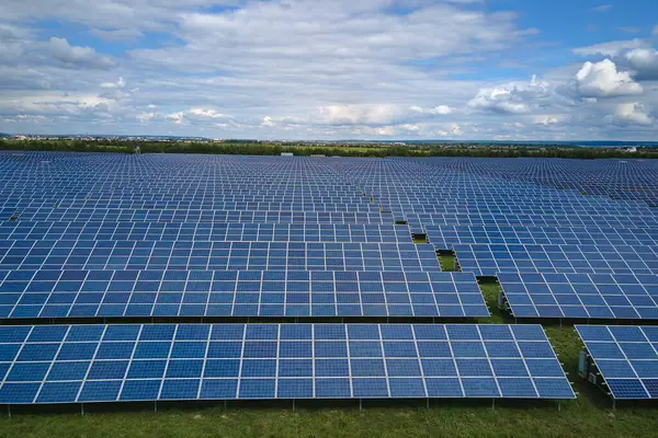 Aerial view of big sustainable electric power plant with many rows of solar photovoltaic panels for producing clean electrical energy. Renewable electricity with zero emission concept.