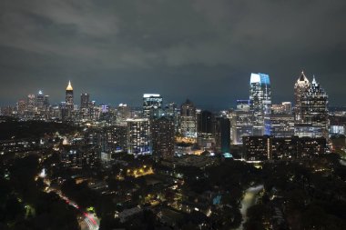 View from above of brightly illuminated high skyscraper buildings in downtown district of Atlanta city in Georgia, USA. American megapolis with business financial district at night.