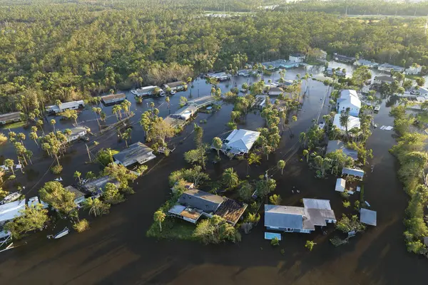Consequences of natural disaster. Heavy flood with high water surrounding residential houses after hurricane rainfall in Florida residential area.