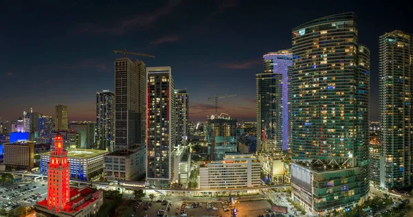 stock image View from above of brightly illuminated skyscraper buildings in downtown district of Miami Brickell in Florida, USA at night. American megapolis with business financial district.