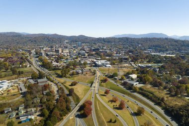 American freeway intersection in Asheville, North Carolina with fast driving cars and trucks in autumnal season. View from above of USA transportation infrastructure.