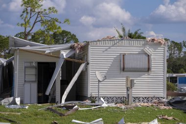 Destroyed by hurricane suburban houses in Florida mobile home residential area. Consequences of natural disaster. clipart