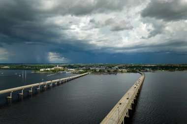 Barron Collier Bridge and Gilchrist Bridge in Florida with moving traffic. Transportation infrastructure in Charlotte County connecting Punta Gorda and Port Charlotte over Peace River.