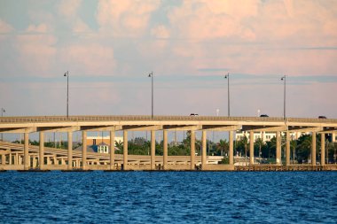 Barron Collier Bridge and Gilchrist Bridge in Florida with moving traffic. Transportation infrastructure in Charlotte County connecting Punta Gorda and Port Charlotte over Peace River.