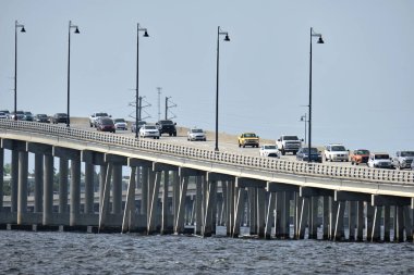 Barron Collier Bridge and Gilchrist Bridge in Florida with moving traffic. Transportation infrastructure in Charlotte County connecting Punta Gorda and Port Charlotte over Peace River.