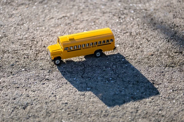 Small model of american yellow school bus as symbol of education in the USA.