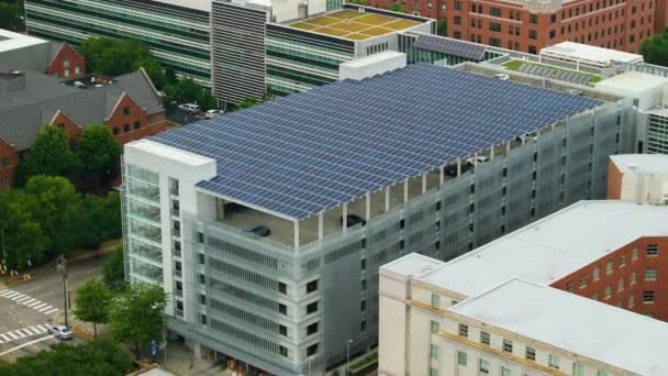 再生可能エネルギーの世代のための駐車場の上の太陽光発電パネル 都市インフラに統合された持続可能な電力生産 — ストック動画
