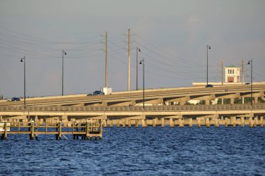 Barron Collier Bridge and Gilchrist Bridge in Florida with moving traffic. Transportation infrastructure in Charlotte County connecting Punta Gorda and Port Charlotte over Peace River.