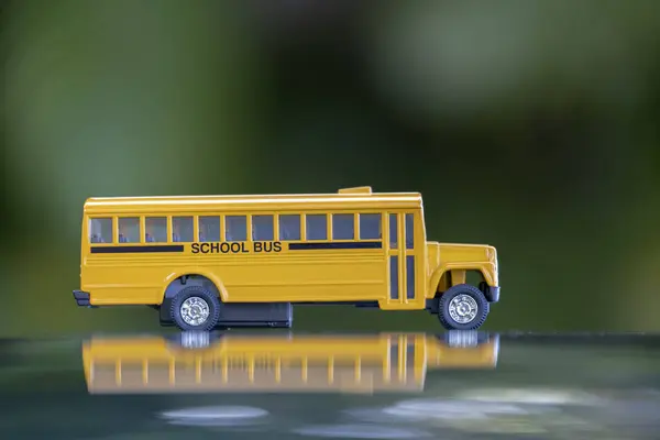 Model of classical american yellow school bus for transporting of kids to and from school every day. Concept of education in the USA.