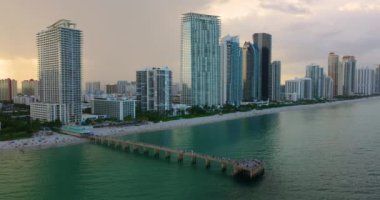 Newport Balıkçılık İskelesi, lüks sahil otelleri ve Atlantik Okyanusu kıyısındaki apartman daireleriyle Sunny Isles Beach 'in hava manzarası. Güney Florida 'daki Amerikan turizm altyapısı.