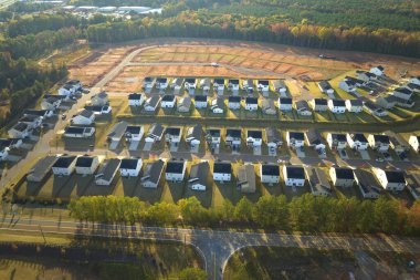 Real estate development with tightly located family houses under construction in South Carolina suburban area. Concept of growing american suburbs.