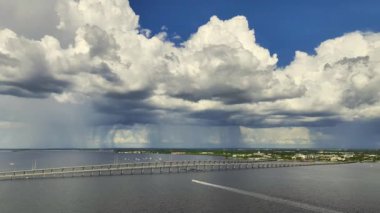 Aerial view of Barron Collier Bridge and Gilchrist Bridge in Florida with moving traffic. Transportation infrastructure in Charlotte County connecting Punta Gorda and Port Charlotte over Peace River.