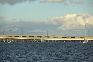 Barron Collier Bridge and Gilchrist Bridge in Florida with moving traffic. Transportation infrastructure in Charlotte County connecting Punta Gorda and Port Charlotte over Peace River.