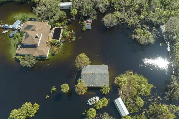 Flooded houses by hurricane Ian rainfall in Florida residential area. Consequences of natural disaster.