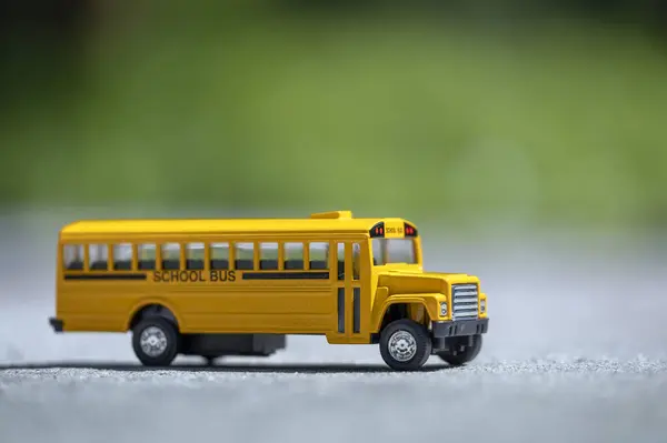 Model of classical american yellow school bus for transporting of kids to and from school every day. Concept of education in the USA.