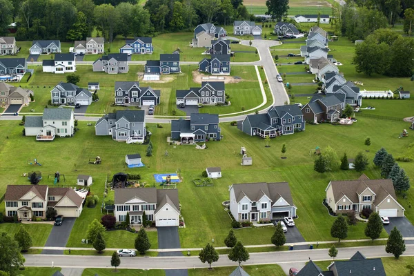 American dream homes as example of real estate development in US suburbs. View from above of residential houses in living area in Rochester, NY.