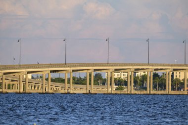 Barron Collier Bridge and Gilchrist Bridge in Florida with moving traffic. Transportation infrastructure in Charlotte County connecting Punta Gorda and Port Charlotte over Peace River.