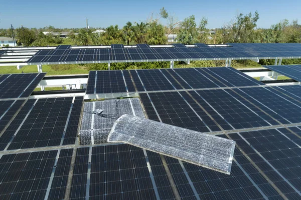 Destroyed by hurricane wind solar panels installed over parking lot canopy shade for parked cars for effective generation of clean energy. Damage from severe weather to Florida infrastructure.