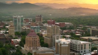 Kuzey Carolina Appalachian şehrinin panoramik hava manzarası Asheville şehir merkezi mimarisi ve günbatımında Blue Ridge Dağı tepeleri. ABD seyahat hedefi.