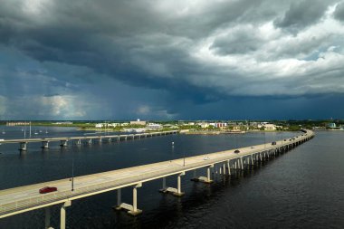 Barron Collier Bridge and Gilchrist Bridge in Florida with moving traffic. Transportation infrastructure in Charlotte County connecting Punta Gorda and Port Charlotte over Peace River.