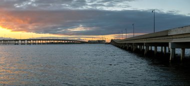 Barron Collier Bridge and Gilchrist Bridge in Florida with moving traffic. Transportation infrastructure in Charlotte County connecting Punta Gorda and Port Charlotte over Peace River.