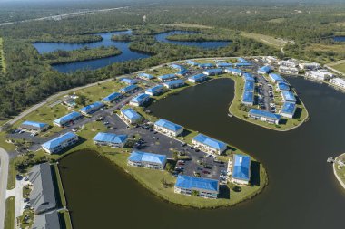 Kasırga hasarlı apartman çatıları, asfalt kiremitleri değişene kadar yağmur suyuna karşı koruyucu plastik muşamba ile kaplı. Doğal afetten sonra.