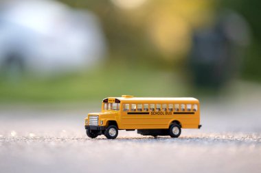 Small model of american yellow school bus as symbol of education in the USA.