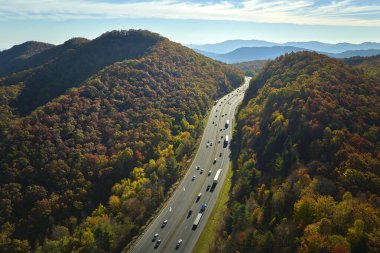 Kuzey Carolina 'da I-40 otobanından Asheville' e giden Golden Fall 'daki Appalachian Dağları' ndan hızla geçen kamyon ve arabalara bakın. Eyaletler arası ulaşım kavramı.