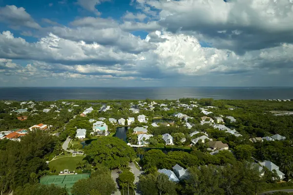 View from above of large residential homes in island small town Boca Grande on Gasparilla Island in southwest Florida. American waterfront houses in rural US suburbs.