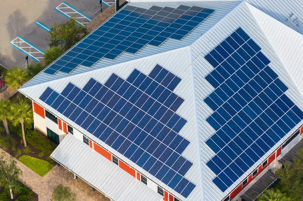 Photovoltaic panels on solar rooftop of Florida commercial building for producing clean ecological electrical energy. Renewable electricity with zero emission concept.