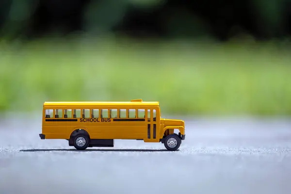Small model of american yellow school bus as symbol of education in the USA.
