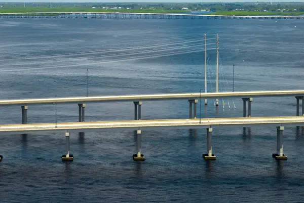 Barron Collier Bridge and Gilchrist Bridge in Florida with moving traffic. Transportation infrastructure in Charlotte County connecting Punta Gorda and Port Charlotte over Peace River.