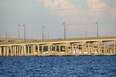 Barron Collier Bridge and Gilchrist Bridge in Florida with moving traffic. Transportation infrastructure in Charlotte County connecting Punta Gorda and Port Charlotte over Peace River.