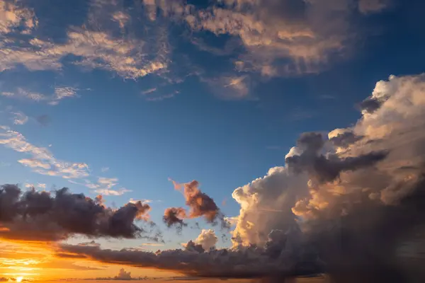 stock image Bright colorful orange and yellow clouds on horizon. Beautiful sunset sky scenery.