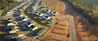Real estate development with tightly located family houses under construction in South Carolina suburban area. Concept of growing american suburbs.