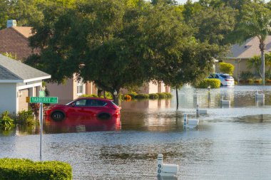 Hurricane Debby tropical rainstorm flooded residential homes and cars in suburban community in Sarasota, Florida. Aftermath of natural disaster. clipart