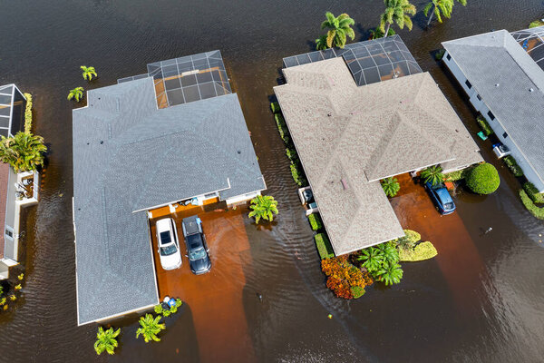 Flooded residential area with underwater cars and houses from hurricane Debby rainfall water in Laurel Meadows community in Sarasota, Florida. Aftermath of natural disaster in southern USA.