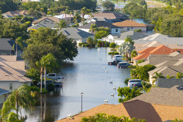 Flooding in Florida caused by tropical storm from hurricane Debby. Suburb houses in Laurel Meadows residential community surrounded by flood waters in Sarasota. Aftermath of natural disaster.