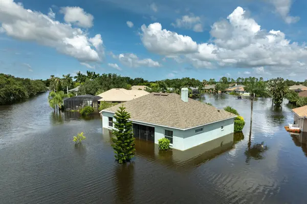 stock image Flooding in Florida caused by tropical storm from hurricane rainfall. Suburb houses in residential community surrounded by flood waters. Aftermath of natural disaster.