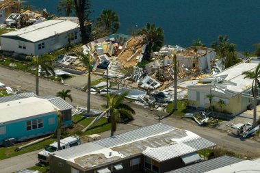 Destroyed by hurricane strong winds suburban houses in Florida mobile home residential area. Consequences of natural disaster. clipart