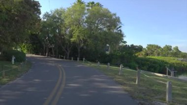 Casey Key kıyı yerleşim bölgesi Picoresque caddesi. Araba bakış açısı güneşli Florida 'da manzaralı yolda gidiyor.