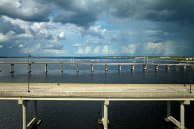 Barron Collier Bridge and Gilchrist Bridge in Florida with moving traffic. Transportation infrastructure in Charlotte County connecting Punta Gorda and Port Charlotte over Peace River.