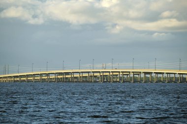 Barron Collier Bridge and Gilchrist Bridge in Florida with moving traffic. Transportation infrastructure in Charlotte County connecting Punta Gorda and Port Charlotte over Peace River.