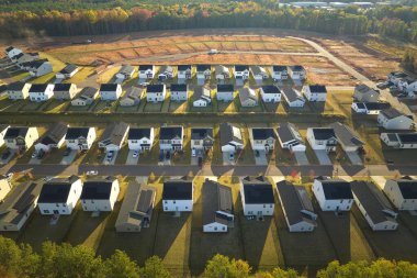 Real estate development with tightly located family houses under construction in South Carolina suburban area. Concept of growing american suburbs.